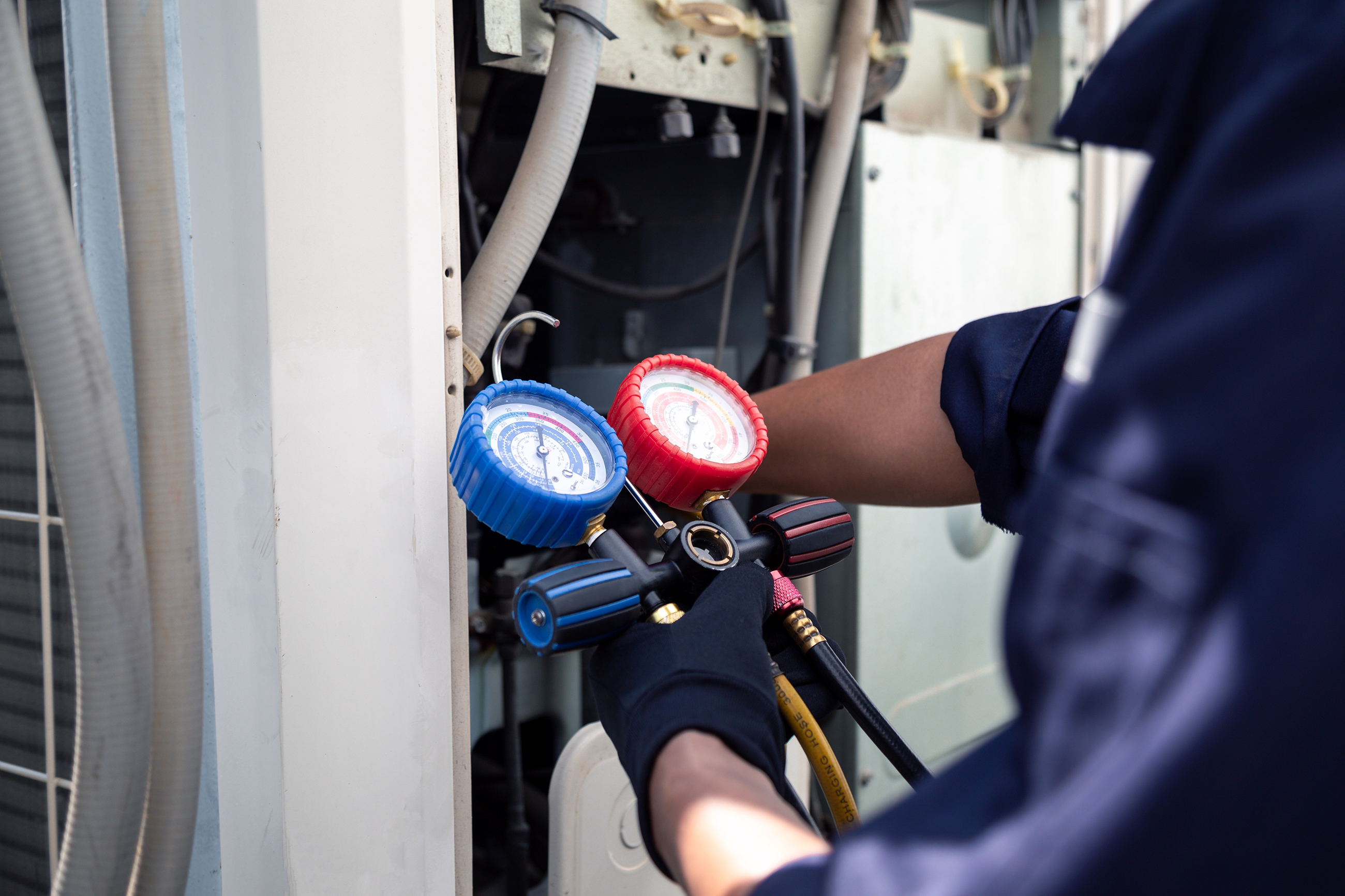 HVAC technician servicing an air conditioning unit
