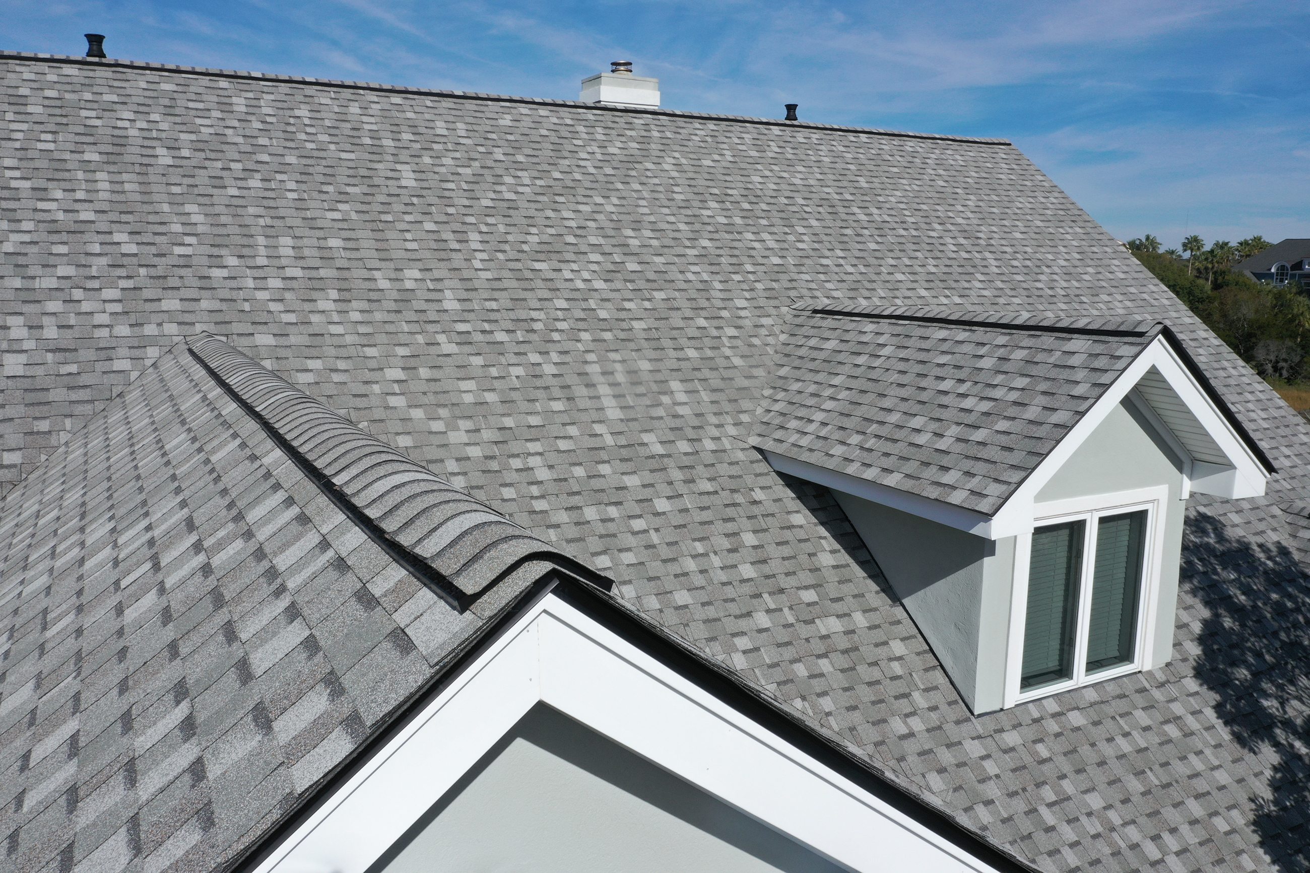 Roofers installing shingles on a home
